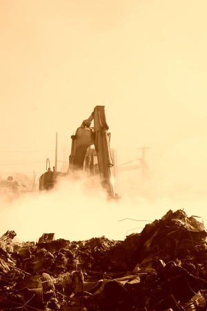 TANGSHAN - NOVEMBER 20: The excavators were clearing up rubbish after fire, November 20, 2013, tangshan city, hebei province, China.のeditorial素材