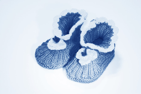 wool woven children's shoes on white background, closeup of photo