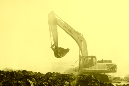 TANGSHAN - NOVEMBER 20: The excavators were clearing up rubbish after fire, November 20, 2013, tangshan city, hebei province, China.のeditorial素材