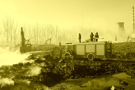 TANGSHAN - NOVEMBER 20: firefighters in sprinkler at the scene of the fire, November 20, 2013, tangshan city, hebei province, China.のeditorial素材