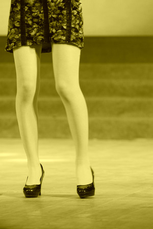 female legs wearing high heeled shoes on the stageの写真素材