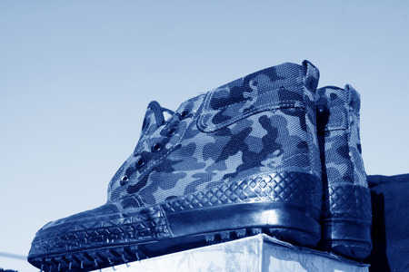 men camouflage rubber shoes in the boothの写真素材