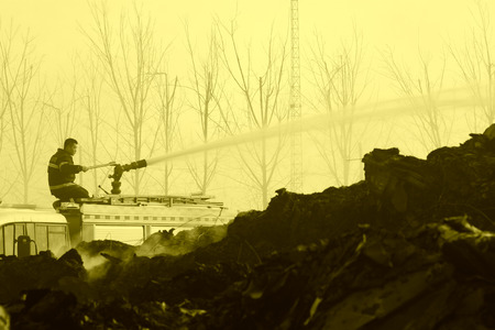 TANGSHAN - NOVEMBER 20: firefighters in sprinkler at the scene of the fire, November 20, 2013, tangshan city, hebei province, China.のeditorial素材
