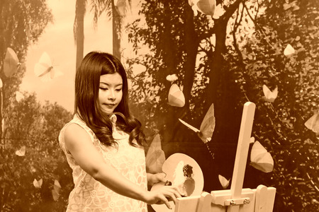 FENGNAN CITY - MARCH 30: A white dress woman was painting, March 30, 2014, Fengnan city, hebei province, China.のeditorial素材