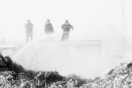 TANGSHAN - NOVEMBER 20: firefighters in sprinkler at the scene of the fire, November 20, 2013, tangshan city, hebei province, China.のeditorial素材