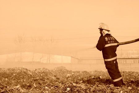 TANGSHAN - NOVEMBER 20: The words "Hebei fire" and "tangshan fire" on the clothes, the fireman at the scene of the fire, November 20, 2013, tangshan city, hebei province, China.のeditorial素材
