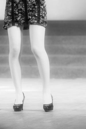 female legs wearing high heeled shoes on the stageの写真素材