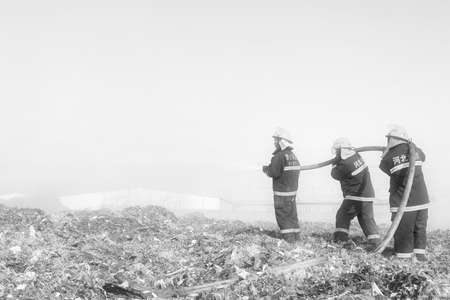 TANGSHAN - NOVEMBER 20: The words "Hebei fire" and "tangshan fire" on the clothes, the fireman at the scene of the fire, November 20, 2013, tangshan city, hebei province, China.のeditorial素材