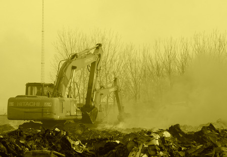 TANGSHAN - NOVEMBER 20: The excavators were clearing up rubbish after fire, November 20, 2013, tangshan city, hebei province, China.のeditorial素材
