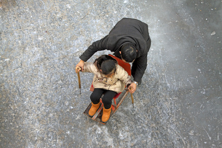 LUAN COUNTY - JANUARY 10: peoples were skating on the ice on January 10, 2015, Hebei Province, Luan County, Chinaのeditorial素材