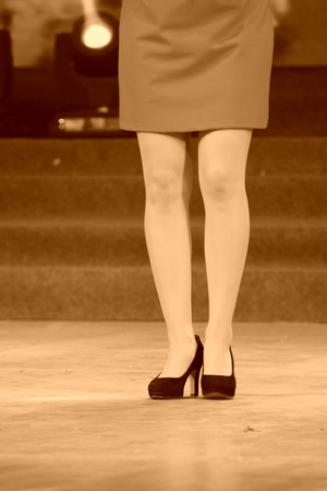female legs wearing high heels on the stageの写真素材