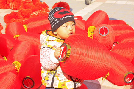 LUANNAN COUNTY - MARCH 5: On the Lantern Festival Day, Children playing with red lanterns in a park, March 5, 2015, luannan county, hebei province, Chinaのeditorial素材