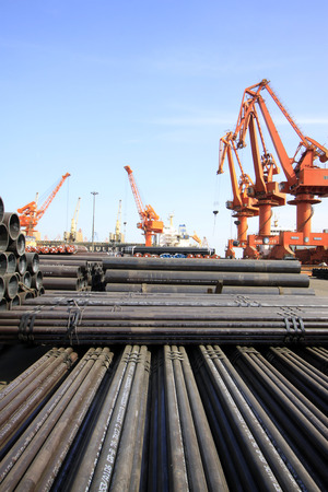 portal crane and pipes on the shipping dock, closeup of photoのeditorial素材