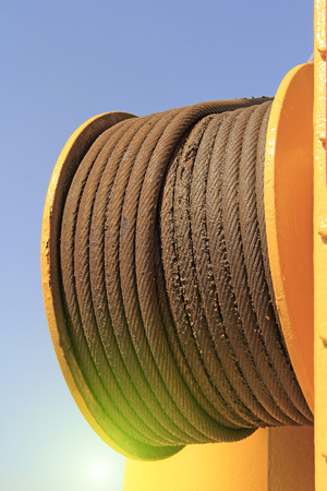 steel wire rope and yellow steel plate, closeup of photoの写真素材