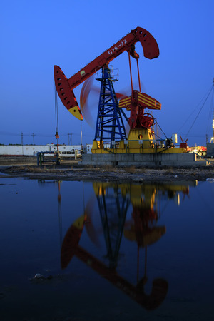 Crank balanced beam pumping unit in Jidong oilfield sunset scenery, Hebei Province, Chinaのeditorial素材