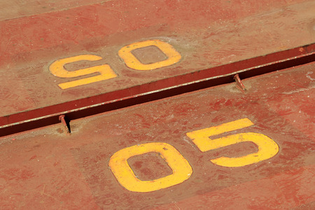 brown number on the plate, closeup of photo