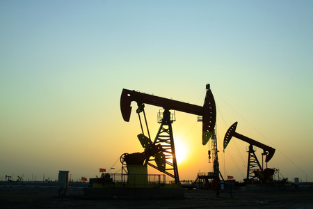 Crank balanced beam pumping unit in Jidong oilfield sunset scenery, Hebei Province, Chinaのeditorial素材