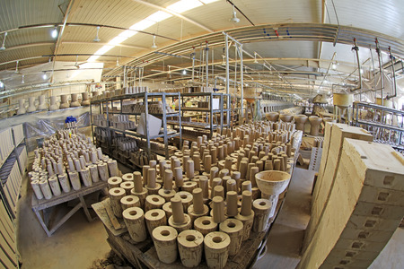 Ceramic unpainted clay idol in production workshop, closeup of photoのeditorial素材