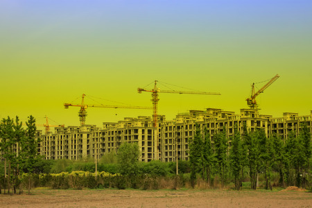 Unfinished buildings and tower crane, closeup of photoのeditorial素材
