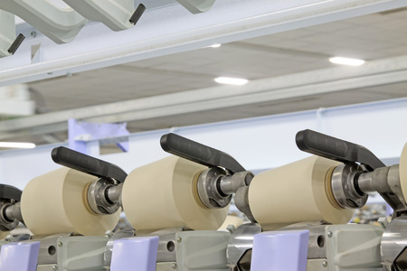 Spinning machinery parts in the factory, closeup of photo