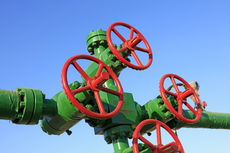 Oil pipeline control handwheel under the blue sky, closeup of photoのeditorial素材