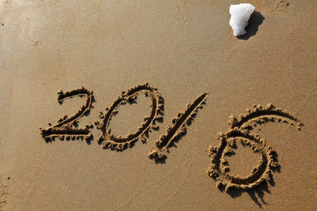 words 2016 handwriting on the beach, closeup of photoの写真素材