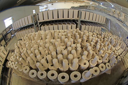 Ceramic unpainted clay idol in production workshop, closeup of photoのeditorial素材