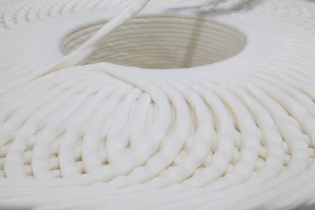 Cotton yarns on the production line, closeup of photo