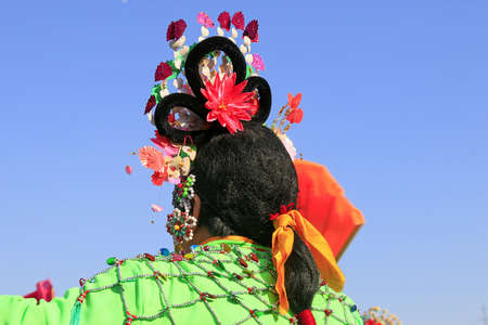 Chinese traditional style yangko folk dance performance headwear in the street, luannan County, hebei Province, Chinaの写真素材