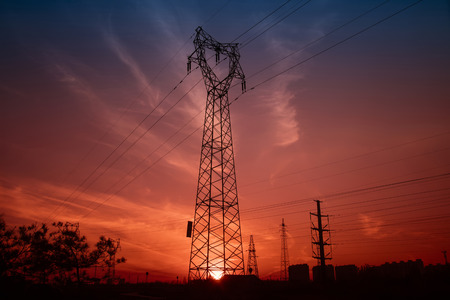 Electric power tower under the setting sunの写真素材