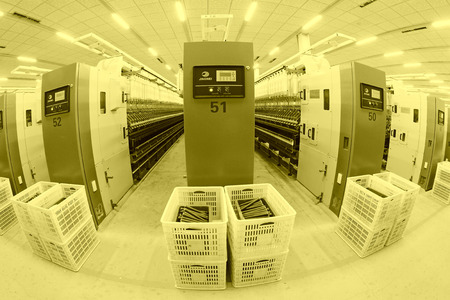 LUANNAN COUNTY - DECEMBER 20: The spinning machinery and plastic crate in a production workshop, in...