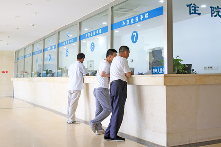 Luannan County - June 18th: Patients' families in the Hospital admission office, June 18th, 2015, Luannan County, Hebei Province, Chinaのeditorial素材
