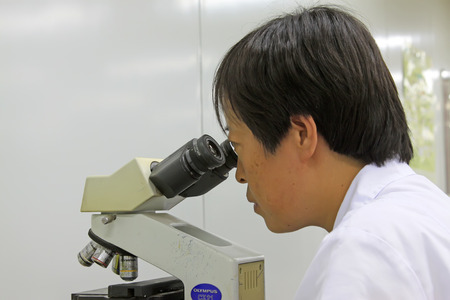 Luannan County - June 18: doctors using microscopy to observe, June 18, 2015, Luannan County, Hebei Province, Chinaのeditorial素材