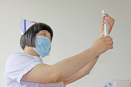 Luannan County - June 18th: a doctor being configured for injection, June 18th, 2015, Luannan County, Hebei Province, Chinaのeditorial素材