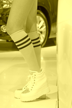 Sportswear yellow socks white shoes, closeup of photoのeditorial素材