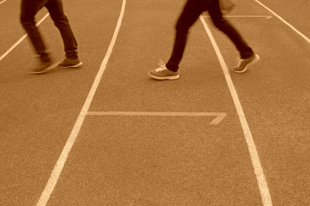 Walking man legs on runway in a sports ground in a middle schoolの写真素材
