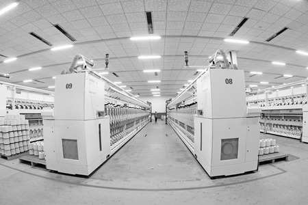 LUANNAN COUNTY - DECEMBER 20: The spinning machinery and cotton yarn in a production workshop, in the ZeAo spinning LTD., on December 20, 2013, Luannan county, hebei province, China.のeditorial素材