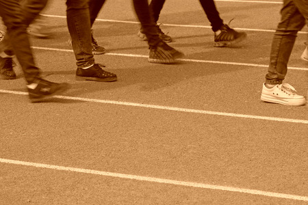 Walking man legs on runway in a sports ground in a middle schoolの写真素材