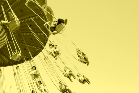 people on rotating facilities in a playground, closeup of photoのeditorial素材