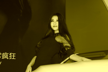 TANGSHAN - MAY 31: Beauty model in a car markets on may 31, 2014, Tangshan city, Hebei Province, Chinaのeditorial素材