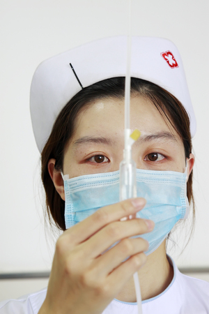 Luannan - June 29: nurse check infusion tube in the hospital, on June 29, 2015, luannan county, hebei province, Chinaのeditorial素材