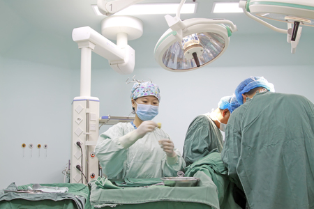 Luannan County - June 18th: medical staff in surgery, June 18th, 2015, Luannan County, Hebei Province, Chinaのeditorial素材