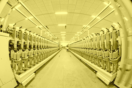 LUANNAN COUNTY - DECEMBER 20: The spinning machinery and equipment in a production workshop, in the ZeAo spinning LTD., on December 20, 2013, Luannan county, hebei province, China.のeditorial素材