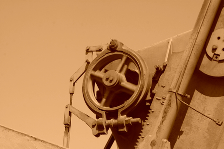 Beam pumping unit rotating wheels, closeup of photoの写真素材