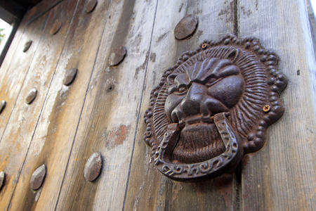 metal beast heads on the door plankの写真素材