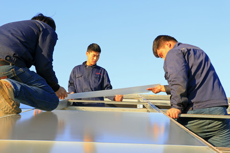 Luannan - December 11, 2015: Engineering and technical personnel to install solar photovoltaic glass.のeditorial素材