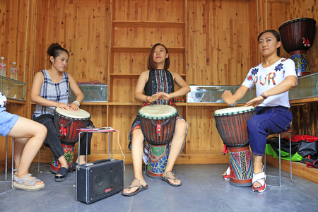 LUAN COUNTY - July 16: African drum performances in wooden house, on July 16, 2016, Luan County, Hebei Province, Chinaのeditorial素材