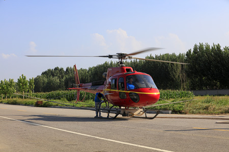 Luannan County - September 3, 2018: Agricultural helicopters are loading fuel and pesticides on highways, Luannan County, Hebei Province, Chinaのeditorial素材