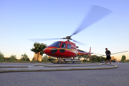 Luannan County - September 3, 2018: Agricultural helicopters are loading fuel and pesticides on highways, Luannan County, Hebei Province, Chinaのeditorial素材