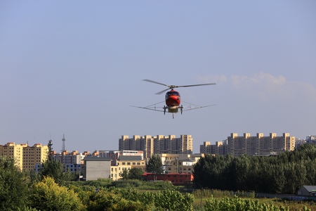Agricultural helicopters flying over the cityのeditorial素材
